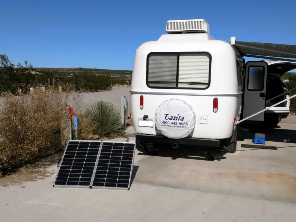 casita rv with zamp solar portable solar panel outside at a campground
